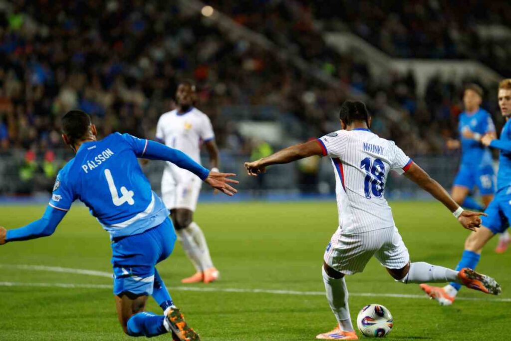 Christopher Nkunku calcia in porta durante Islanda-Francia, partita di qualificazione al Mondiale 2026.