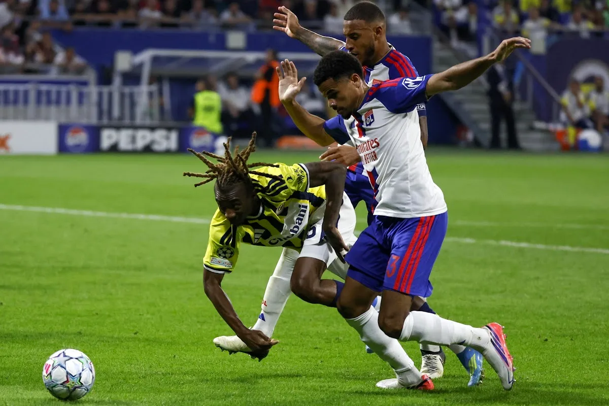 Athekame del Lione con maglia bianca e blu numero 3 contrasta un avversario del Fenerbahce in Champions League